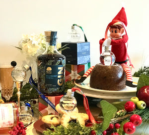 Blueberry Gin next to Christmas pudding with elf and baubles