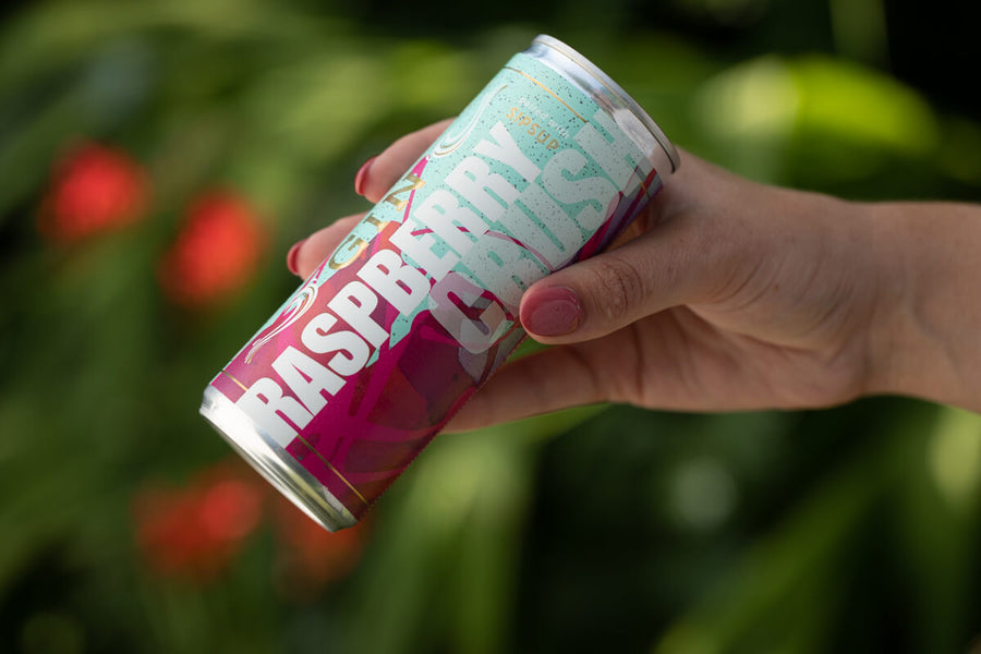 Hand holding a canned RTD called Raspberry Crush