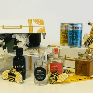 Flight of the Honeybee Gin Tasting Set showing contents of box with chocolate bees in focus